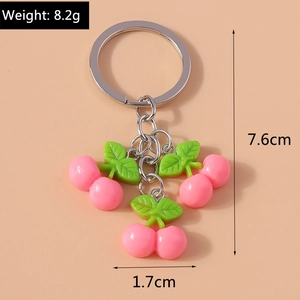 Detailed view of pink cherry keychain with measurements showing 7.6cm length and 8.2g weight