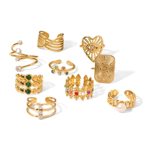 Detailed macro shot of 9-piece vintage gold-plated rings with turquoise and zircon inlays