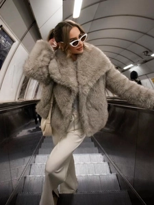 Close-up of the soft gray faux fur texture and wide lapel of this short winter coat