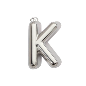 Macro detail of high polished silver 3D balloon letter K pendant in stainless steel