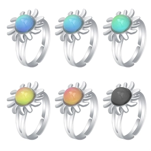 Macro shot of sun-shaped mood rings showing diverse color-changing gemstone effects