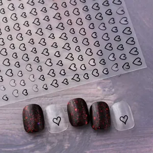 Detailed close-up of hollow black heart nail stickers on clear film for nail art decor