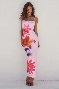 Detail of floral print pattern on pink bodycon maxi dress with red and purple lilies