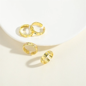 Adjustable 14K gold plated copper rings with sparkling zircon evil eye motifs on a white plate