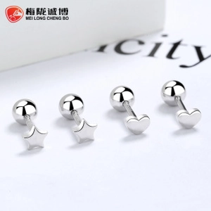 Macro detail of 925 sterling silver heart and star stud earrings with screw back balls
