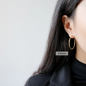 Minimalist S925 sterling silver 30mm golden hoop earrings on a female model
