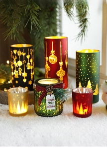 Close-up of elegant Christmas glass candle holders with snowflake and tree patterns