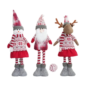 Three plush Christmas figurines featuring Santa, Snowman, and Reindeer in red outfits