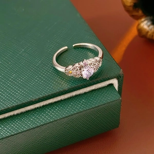 Detailed close-up of a silver crown ring featuring a lavender zircon and filigree details