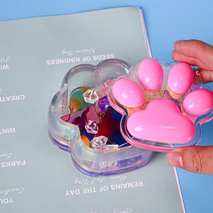 Close-up of cat paw storage box with laser rainbow finish and pink silicone detail