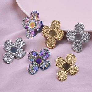 Detailed view of six clover shaped stainless steel earring bases in gold and silver