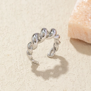 Detailed close-up of a silver twisted spiral open ring with polished metal texture