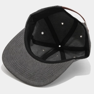 Detail view of cotton baseball cap interior featuring reinforced stitching and leather strap