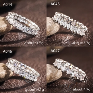 Macro detail of silver eternity bands showing oval, marquise, square and heart stone cuts