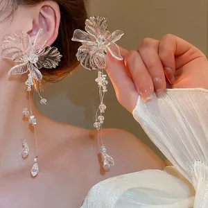 Exaggerated transparent flower tassel earrings with crystal beads on model