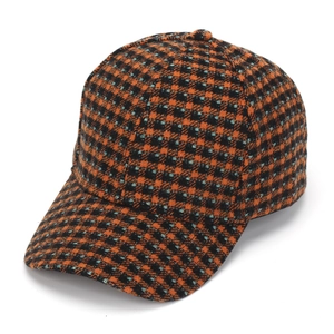 Detailed view of orange and cyan plaid tweed baseball cap with six-panel design
