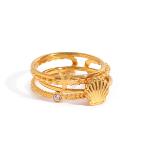 Three-piece golden ocean rings set featuring shell, starfish, and rhinestone accents
