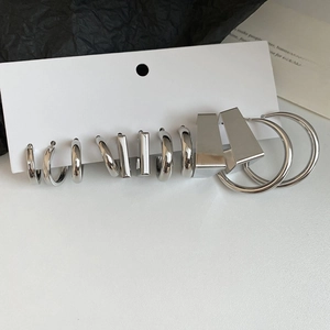 Detailed view of silver geometric hoop earring set with high-polish metallic finish
