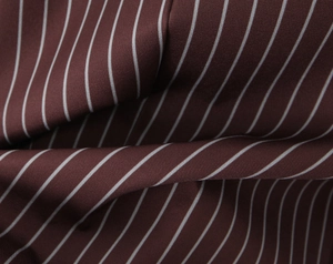 Close-up of the burgundy striped fabric texture with detailed weave for women's blazer