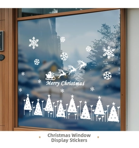 Detailed view of white snowflake stickers and Merry Christmas decals on a glass window