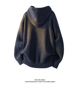 Detail of navy blue heavy knit hoodie showing thick texture and ribbed hem craftsmanship