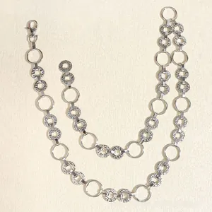 Detail of silver double-layered metal waist chain with textured rings and lobster clasp