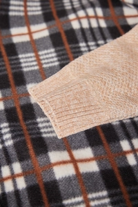 Macro shot of men's beige knitted sweater ribbed cuff and detailed fabric texture
