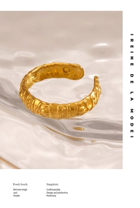 Macro shot of hammered texture gold flower ring on water ripple background