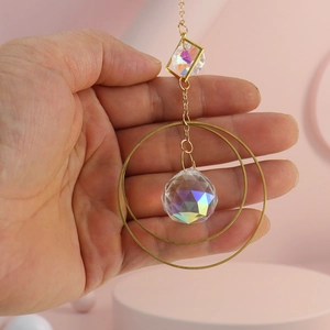 Detail of crystal suncatcher with gold metal frames and AB colorful prism ball