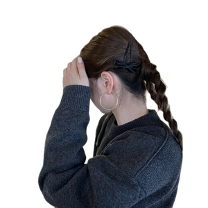 Silver hoop earrings and black bow hair clip shown on model for a trendy Korean style look