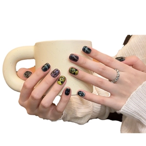 Short Halloween cat eye press-on nails with dark skull and cross patterns on hands