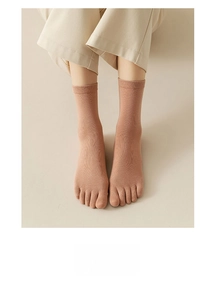 Detailed close-up of breathable five-toe acupoint massage socks in rose pink finish