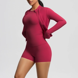 Detail of berry red high-stretch athletic three-piece set showing slim fit and zipper jacket