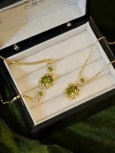 Detail view of oval emerald zircon necklace and bracelet set in luxury display box