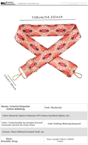 Close-up of ethnic geometric woven shoulder strap with gold metal lobster clasps