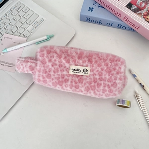 Pink leopard plush cosmetic pouch and stationery bag with fuzzy texture on desk setup