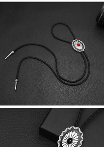 Macro shot of Celtic style bolo tie featuring red and black turquoise floral pendants