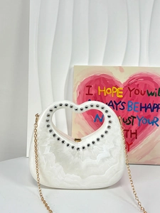 White heart-shaped acrylic handbag with stone texture, rhinestone handle and gold chain