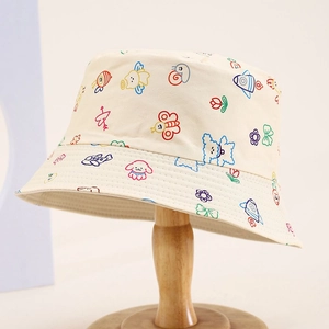 Kids' reversible bucket hat with colorful cartoon animal doodle prints on beige canvas