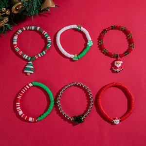 Detailed view of six Christmas-themed handmade beaded bracelets with festive pendants