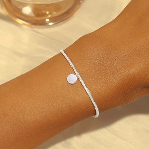 Close-up of S925 sterling silver chain bracelet with moonstone on woman's wrist