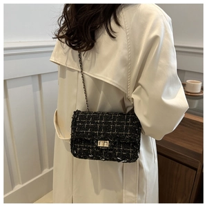 Close-up of the woven tweed texture and fringe edge details on the chain shoulder bag