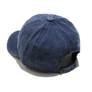 Detail view of the washed navy blue baseball cap back with adjustable strap and JC tag