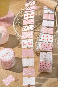 Close-up of pink floral stickers and decorative washi tape for DIY scrapbooking
