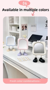 Three cartoon desktop makeup mirrors in blue, pink, and cream white with cute leg stands