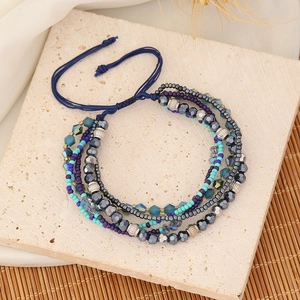 Detail of bohemian woven multi-layer beaded bracelet with blue and purple crystal beads