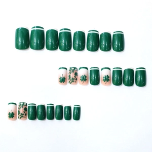 French press-on nails with green four-leaf clover patterns and tiny rhinestones