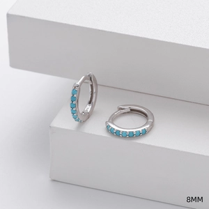 Detailed view of 8mm sterling silver hoop earrings with turquoise stone inlay