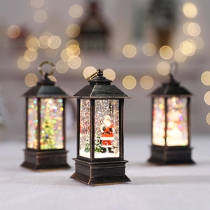 Christmas lantern with Santa Claus figurine featuring LED lights and snow effect