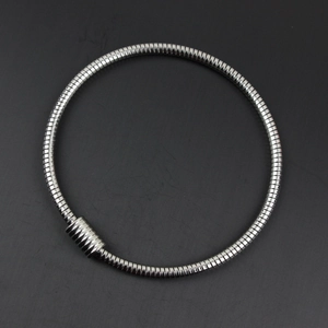 Macro shot of silver stainless steel snake chain bracelet with magnetic closure